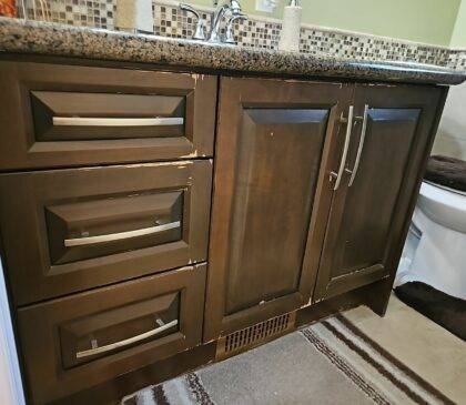 Close up of washroom cabinets in need of a new paint job.