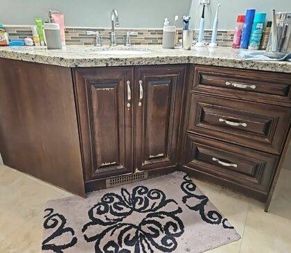 Close up picture of bathroom cabinets that are in need of a new paint job.