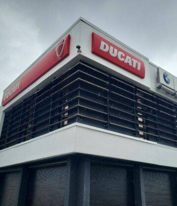 Close up of Ducati motors in Vancouver, where the existing red colour was turned into a white colour after the Oriah Contracting's exterior commercial painting services.