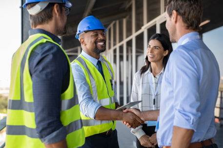 Engineer and businessman handshake at construction site 164999718 e1728543731522