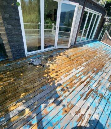 Residential deck that is in need of a new paint job as it is completely peeling apart. Pressure washing was done to help with the scraping that would be done.