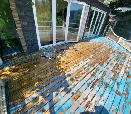 Residential deck that is in need of a new paint job as it is completely peeling apart. Pressure washing was done to help with the scraping that would be done.