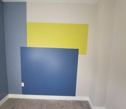 A bedroom wall that became a feature wall. Lots of different colours and patterns make this wall stand out!