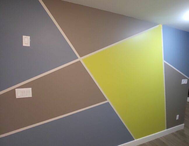 A basement wall that has a pattern of colours from oriah contracting interior painting services!