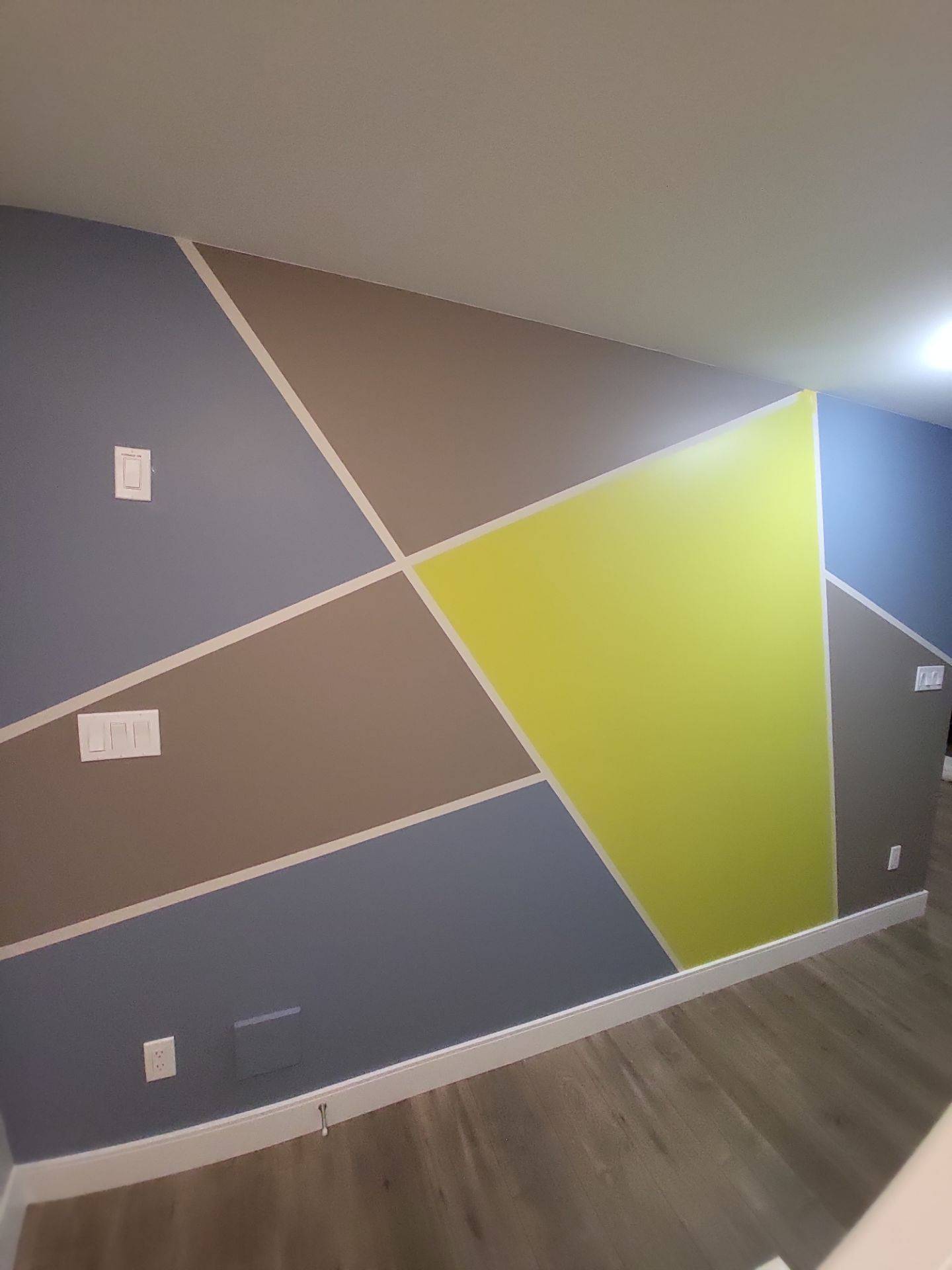 A basement wall that has a pattern of colours from oriah contracting interior painting services!